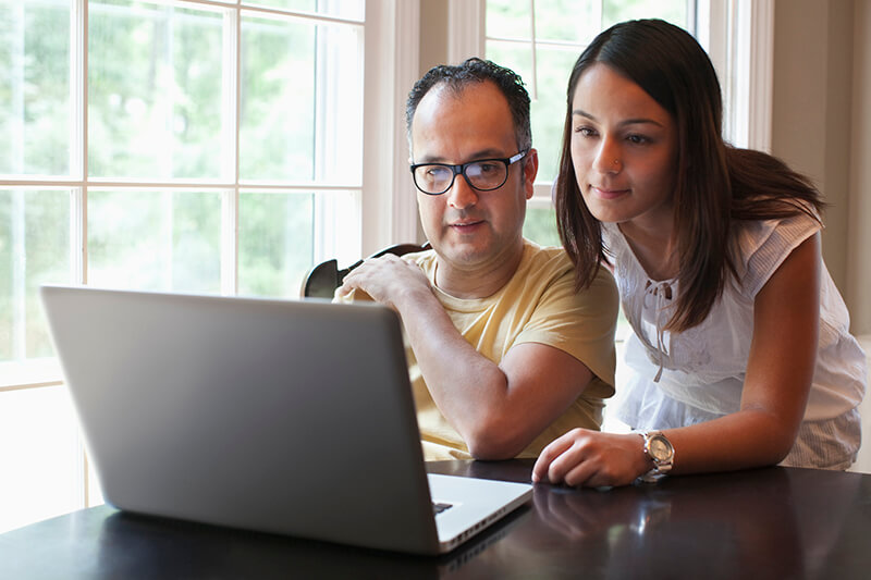 Hispanic couple using laptop together